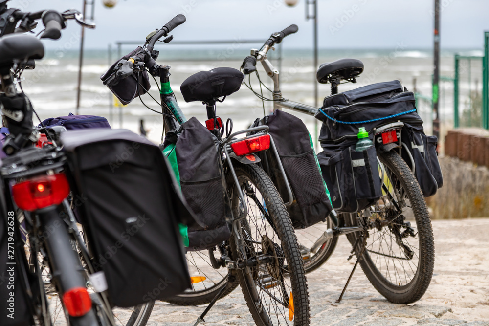 Tourist trekking bikes parked close to the beach and sea.