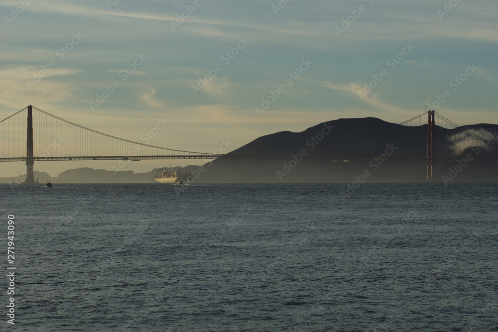 SAN FRANCISCO, CALIFORNIA, UNITED STATES - NOV 25th, 2018: MSC Cargo Ship SILVIA entering the San Francisco Bay under the Golden Gate Bridge on its way to the Port of Oakland - a fully loaded