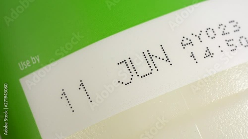 Use by date printed on a fresh milk bottle label. Food and drink safety.