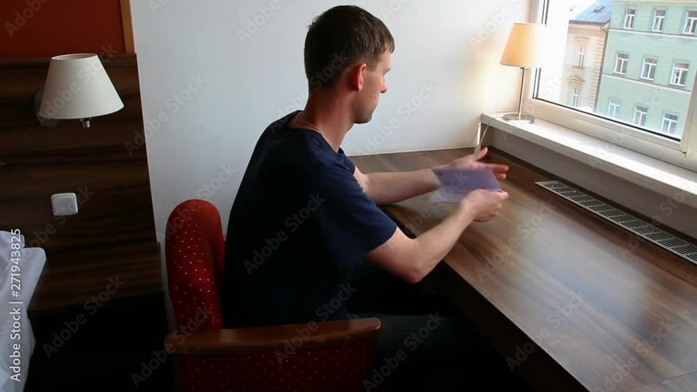 Young man check document in hotel room Young man check document in hotel room