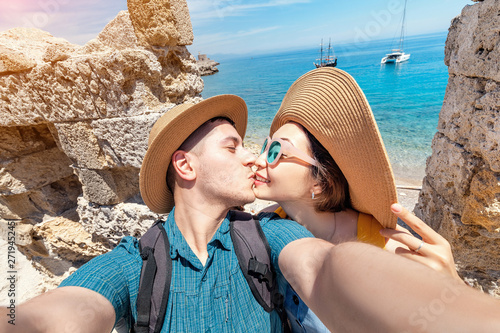 Two people in love hugging and taking selfie in old fortress with view to the sea resort. Couple travel and honeymoon trip