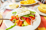 Greek Salad Horiatiki in plate with Feta Cheese and Olives. Greek traditional cuisine concept