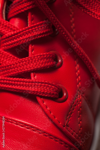 Closeup view of sport shoe. Red shoelaces closeup.