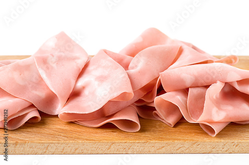 Detail of Italian mortadella on cutting board, on a white background