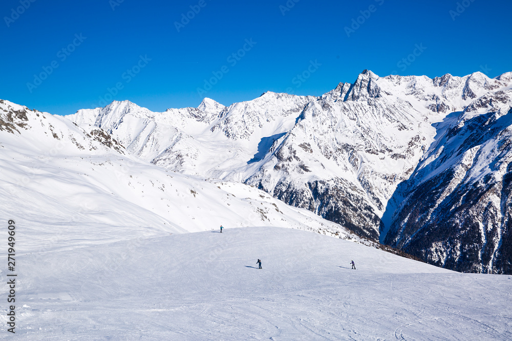 Ski slope in Alp mountains and beautiful sunny day in Tirol, Austria. 