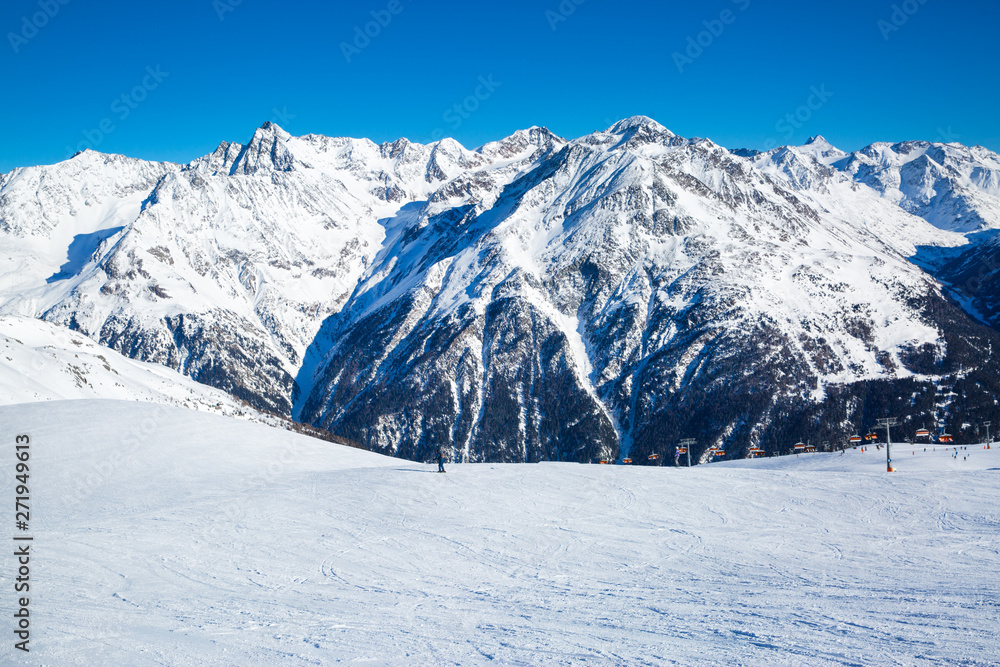 Ski resort slope, huge Alp mountains, covered with snow in Tirol, Austria. 