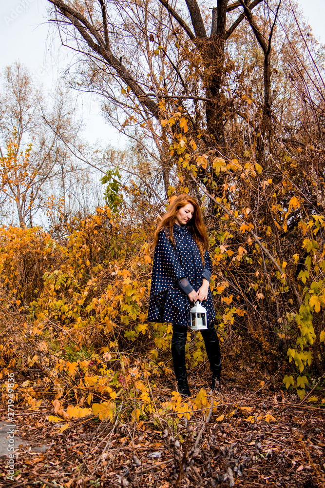 young redhead woman with white lamp in the hand in autumn park young redhead woman with white lamp in the hand in autumn park