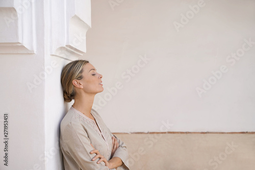 Natural beauty leaning against pillar in Moroccan villa in neutral tones photo