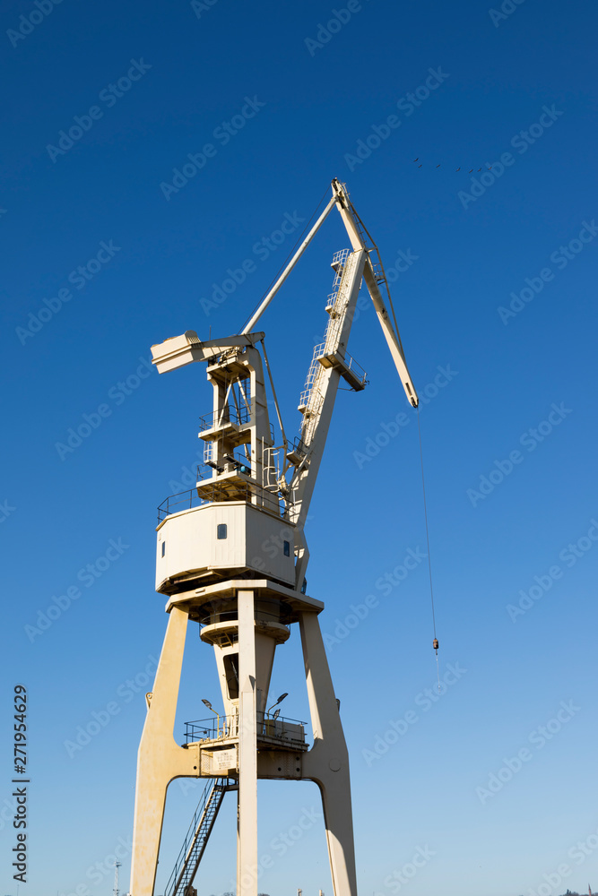 Mobile harbor cranes over blue sky. Transport and technology concept Mobile harbor cranes over blue sky. Transport and technology concept