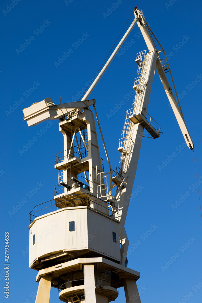Mobile harbor cranes over blue sky. Transport and technology concept Mobile harbor cranes over blue sky. Transport and technology concept