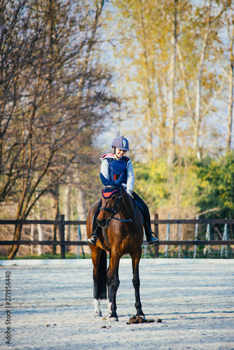 13-year-old girl riding her horse during a lesson