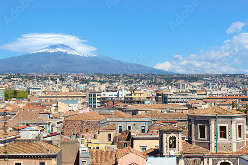 Amazing cityscape of Sicilian city Catania, Italy captured with majestic Etna volcano in the background. Snow on the very top of the mountain. Sunny day © ppohudka