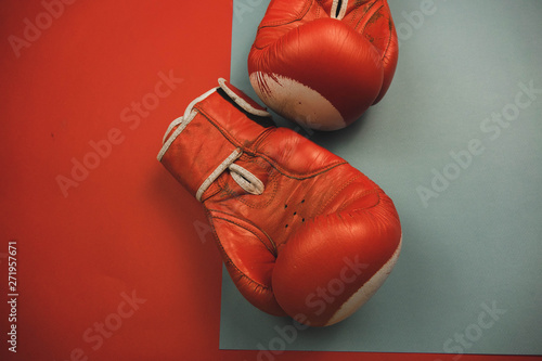 red boxing gloves on a red and blue background.
