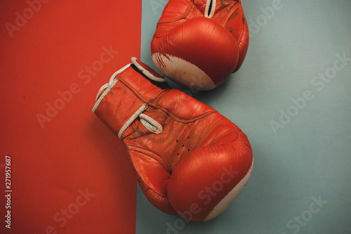 red boxing gloves on a red and blue background.