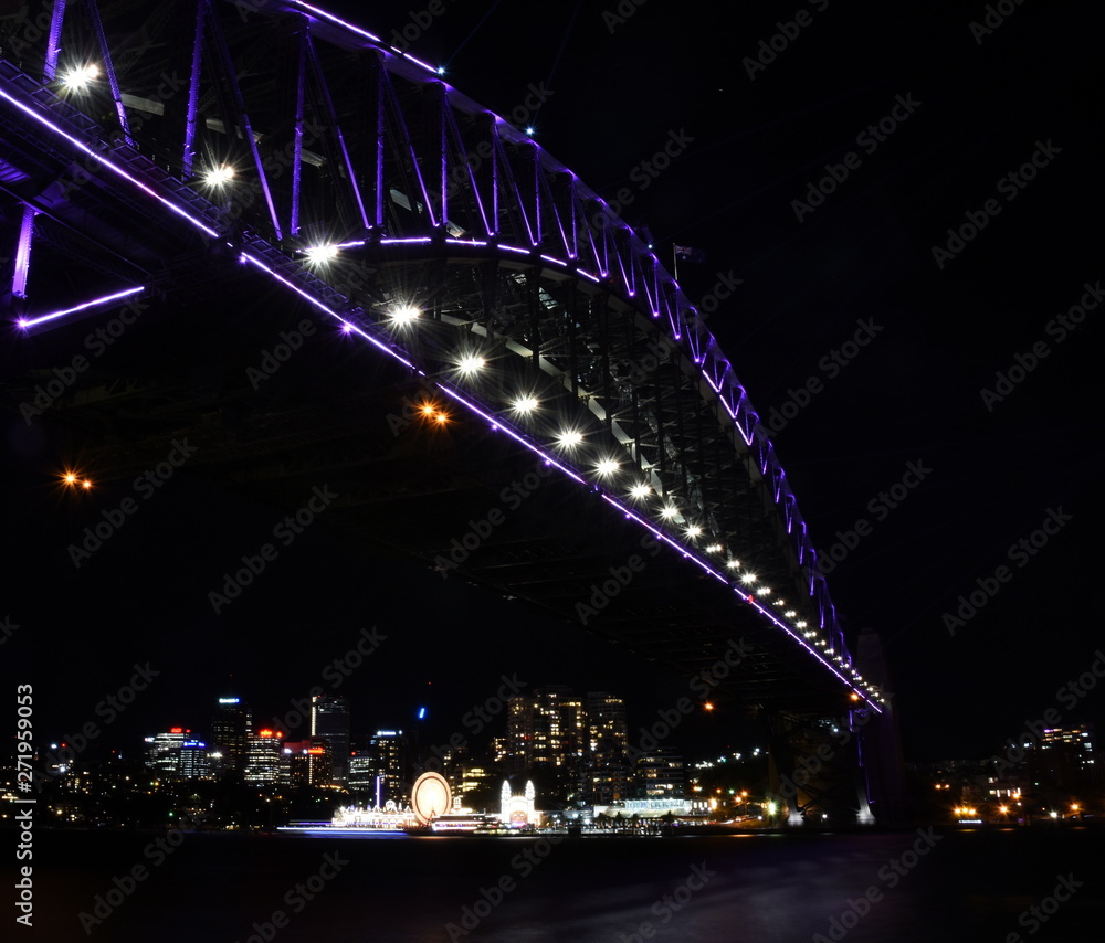 Obraz premium Sydney, Australia - May 27, 2019. Harbour Bridge and Luna Park illuminated with colourful light design imagery during the Vivid Sydney 2019 free annual public event.
