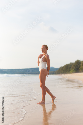 Model on the beach in white dress 