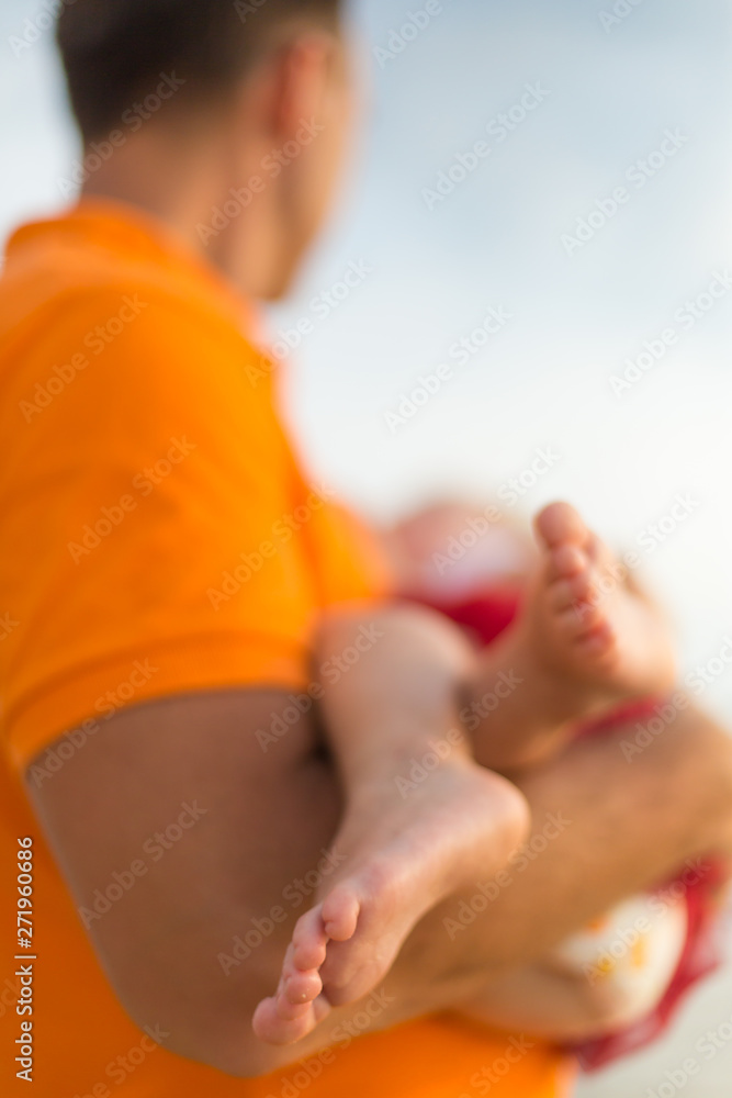 Baby foot in hands of father
