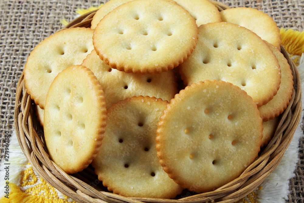 Top view of round salted snack cracker cookie isolated in basket