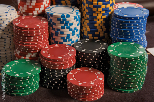 Close-up shot of a poker chips stacks standing on a table in casino.