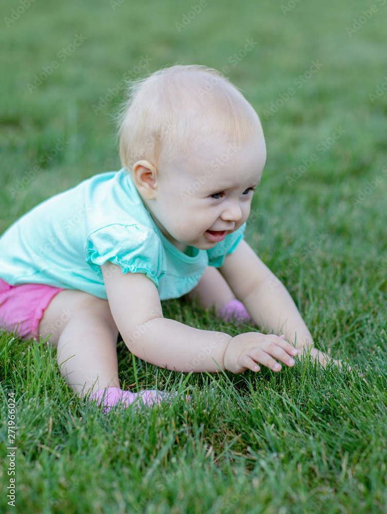Happiness Baby girl sitting on the grass in field Happiness Baby girl sitting on the grass in field