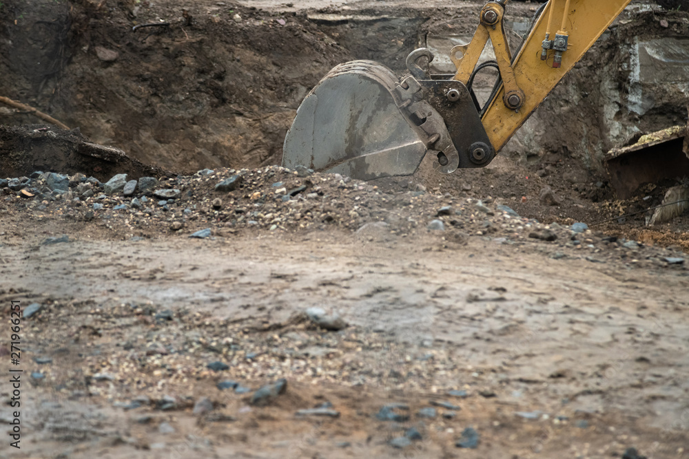 Big industrial excavator digging up ground, urban development. Bulldozer scoop working in construction site