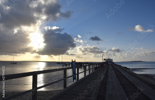 The Kingfisher Bay ferry departs Fraser Island at sunset. World Heritage-listed Fraser Island is the world   s largest sand island.