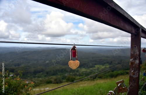 Couples showing their everlasting love (Love you forever) by attaching a coloured padlock to the Gerrards lookout iron fence of the  as a token of love. photo