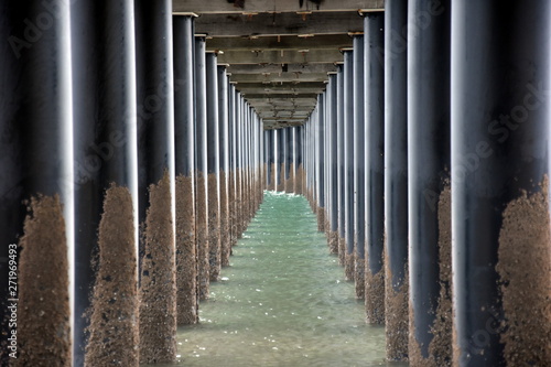 Under Urangan pier perspective view. Under a pier in Hervey Bay (Queensland, Australia), showing the structure of the pilings and support structure. photo