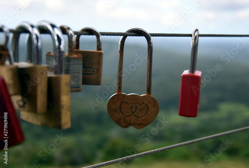 Couples showing their everlasting love (Love you forever) by attaching a coloured padlock to the Gerrards lookout iron fence of the  as a token of love. photo