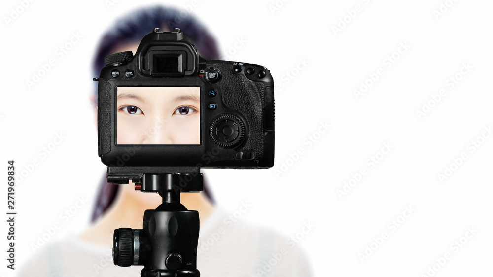 Focus on live view on camera on tripod, teenage girl   with blurred scene in background. Teenage vlogger livestreaming show concept