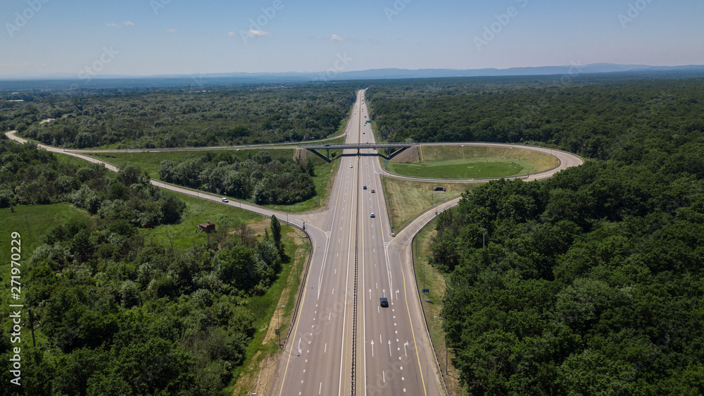 Aerial view of highway cloverleaf interchange seen from above.