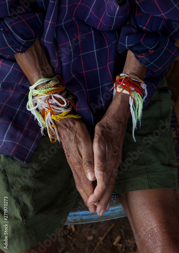 Man with baci strings bracelets, Boloven, Laos photo
