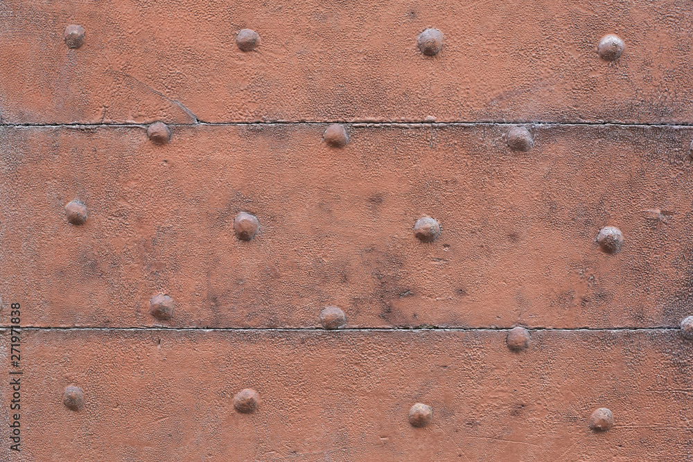 Old wooden, brown painted, door with nails texture background Old wooden, brown painted, door with nails texture background