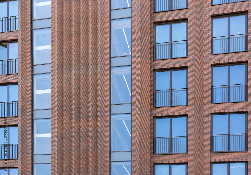 Residential building in loft style. Large Windows in a red brick wall. Residential building in loft style. Large Windows in a red brick wall.