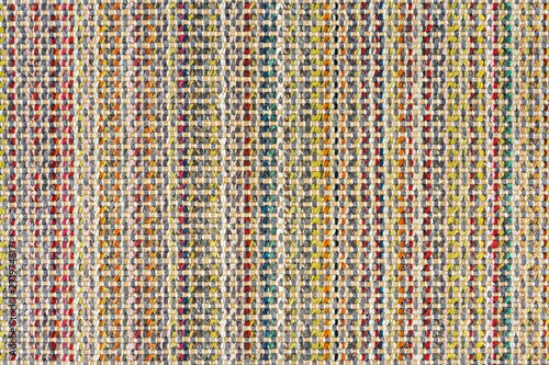 Multicolored knitted fabric background texture. Сolorful fabric with a pattern, Fragment colored wool carpet, bright wicker colorful rug