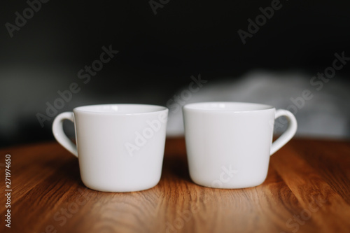 Two cups on wooden table. Morning coffee 