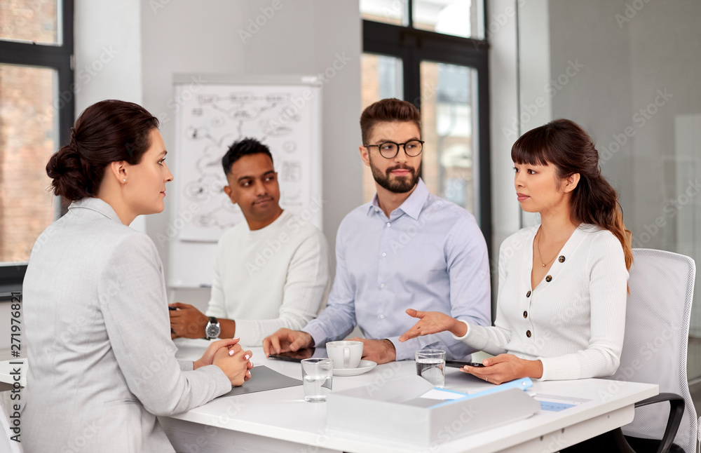 new job, hiring and employment concept - international team of recruiters having interview with female employee at office new job, hiring and employment concept - international team of recruiters having interview with female employee at office
