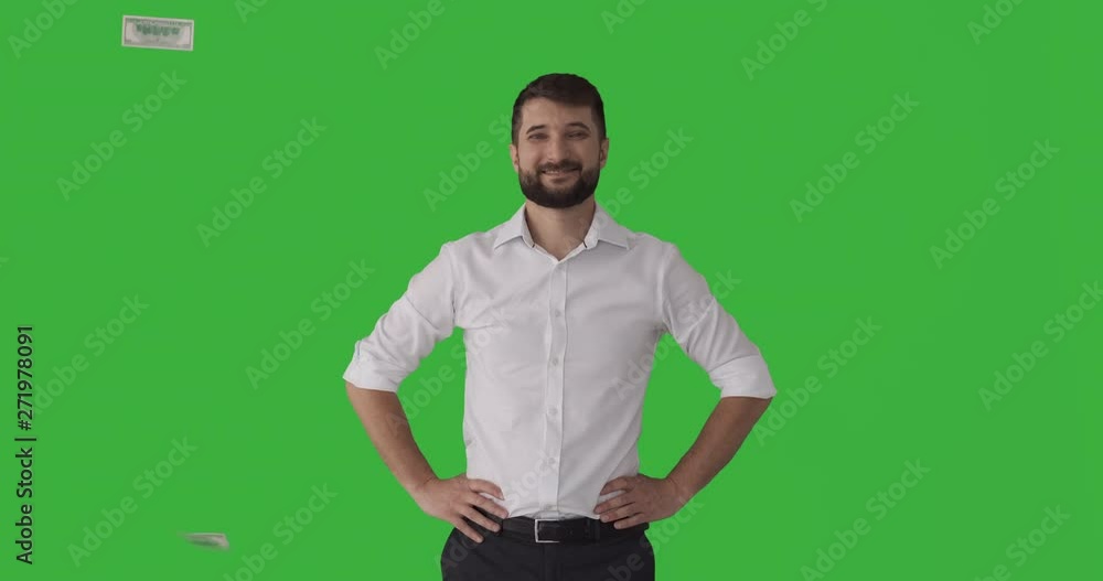 Hundred dollar bills falling over successful businessman on green chroma key background Hundred dollar bills falling over successful businessman on green chroma key background