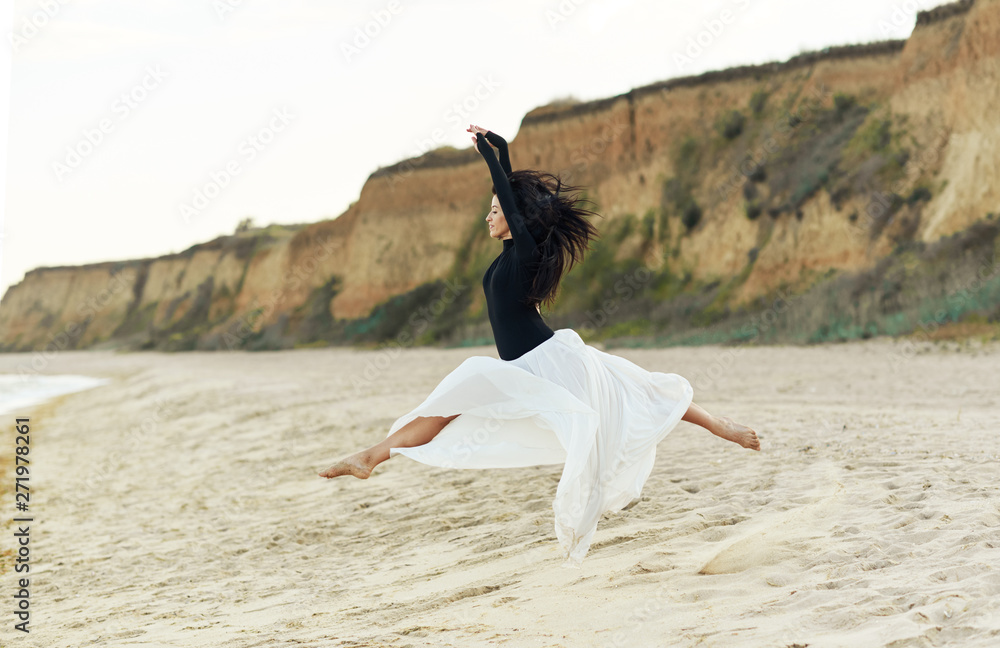 Ballet woman Dancer at Sunset beach. Classical dance in white chiffon skirt Ballet woman Dancer at Sunset beach. Classical dance in white chiffon skirt