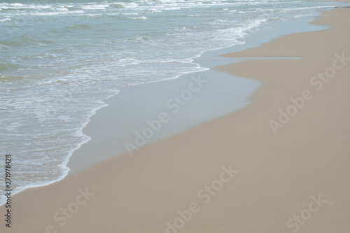 Close up detail of the sea waves washing ashore at the beach Asia