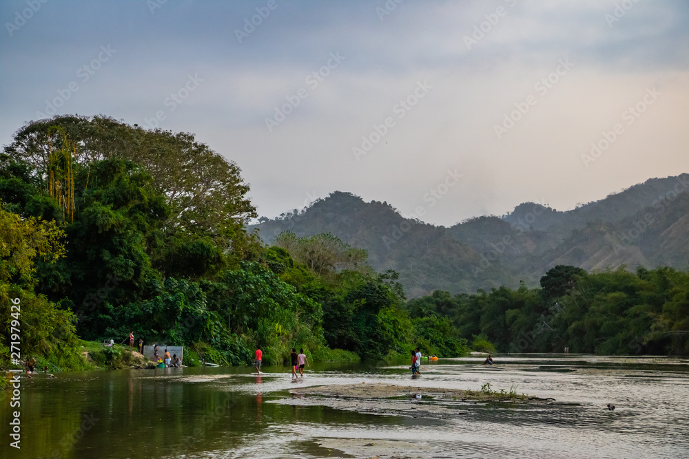 Fototapeta premium local people swimming in a river in the rainforest of south america