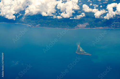 Sea Aerial view, Top view photo from airplane overlooking the clouds, the coastline and the island with beautiful blue-green sea water.
