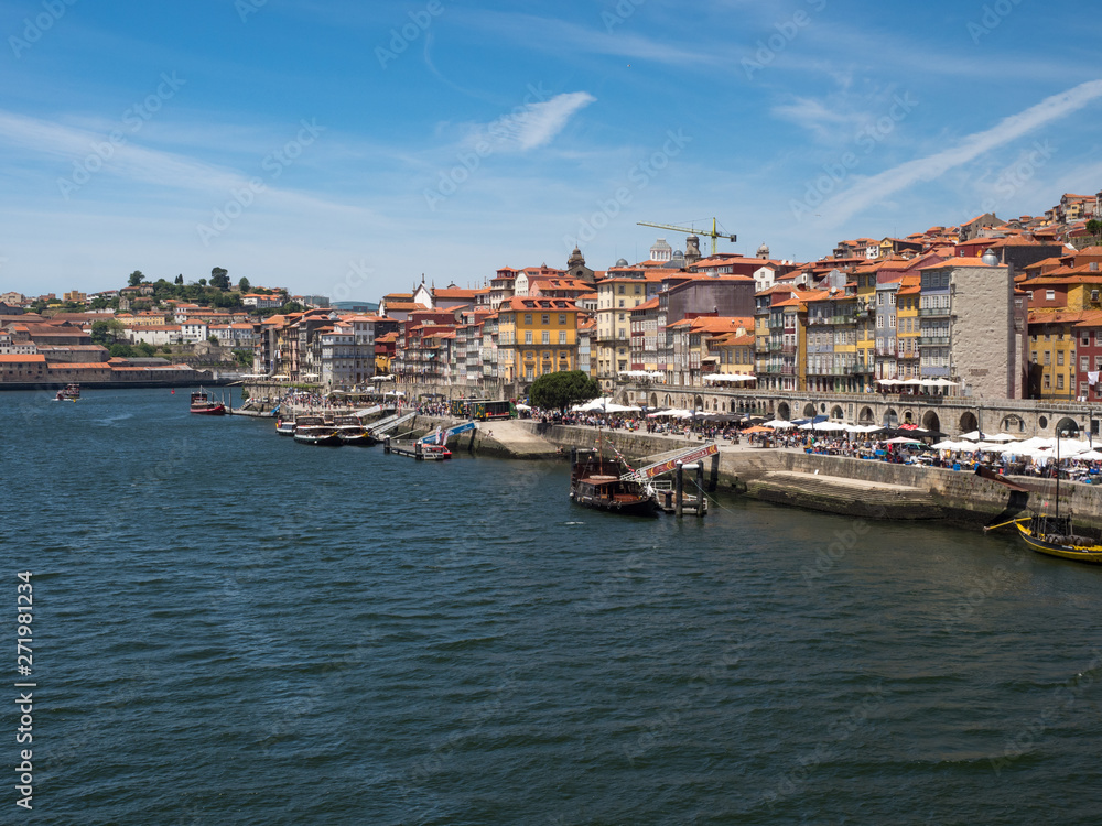 Porto, Portugal old town ribeira aerial promenade view with colorful houses, Douro river and boats. May 2019