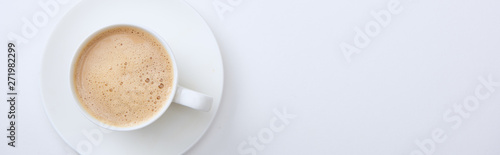 panoramic shot of white cup with delicious hot coffee on white background