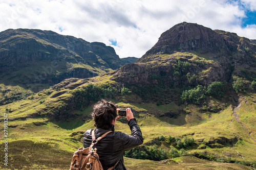 Panoramic view of the Three Sisters of Glencoe with tourist, Scotland, UK.