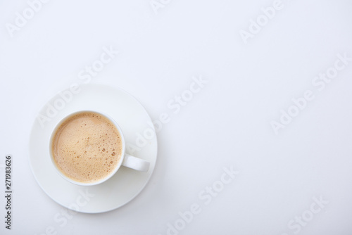 top view of delicious coffee with foam on white background with copy space
