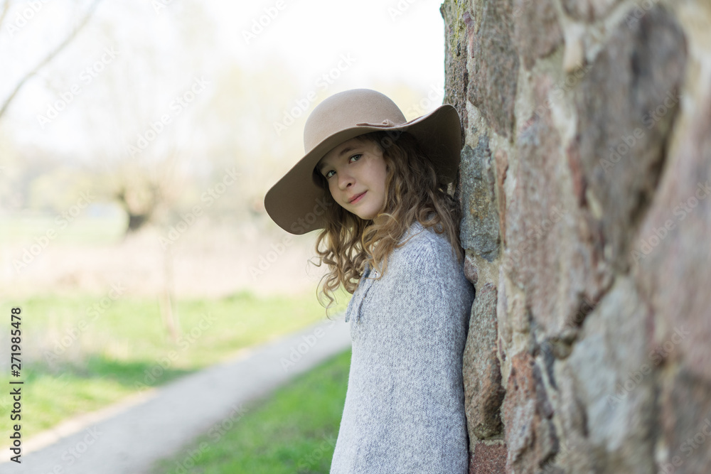 Portrait of a beautiful young girl in a hat.