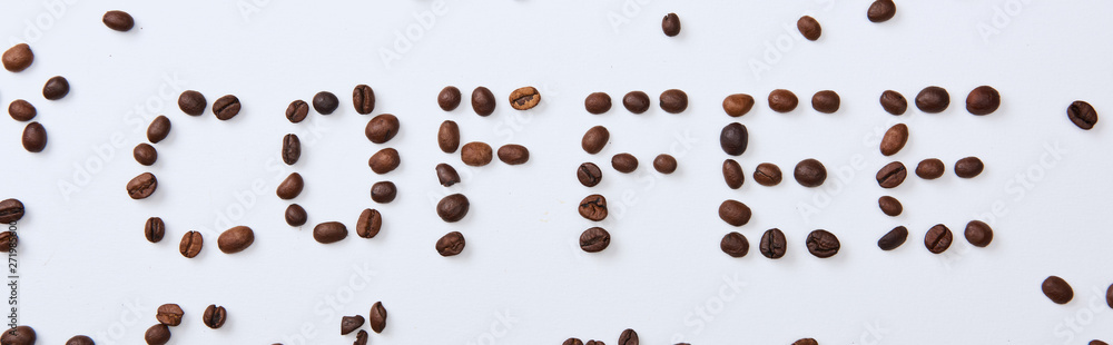 panoramic shot of of coffee lettering made of beans on white background panoramic shot of of coffee lettering made of beans on white background