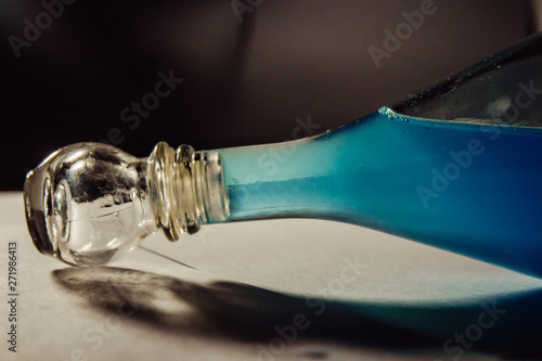 glass bottle with blue liquid