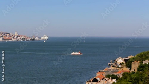 High angle view of ferry boat crossing river from Lisbon city to Lisbon south bay photo